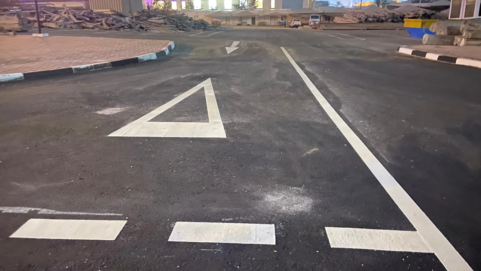 Thermoplastic road marking application in progress on Doha highway Qatar